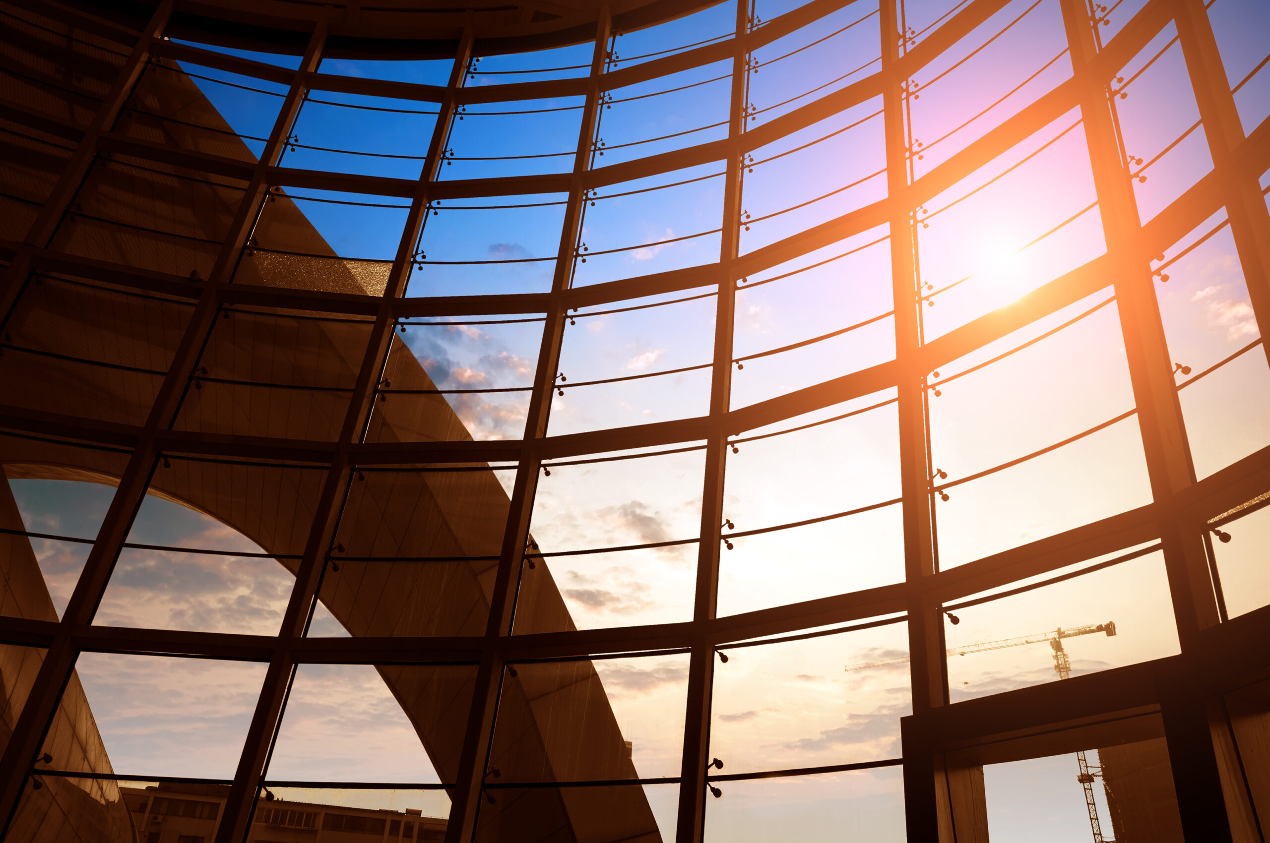 Image of windows in modern office building with sun shining through