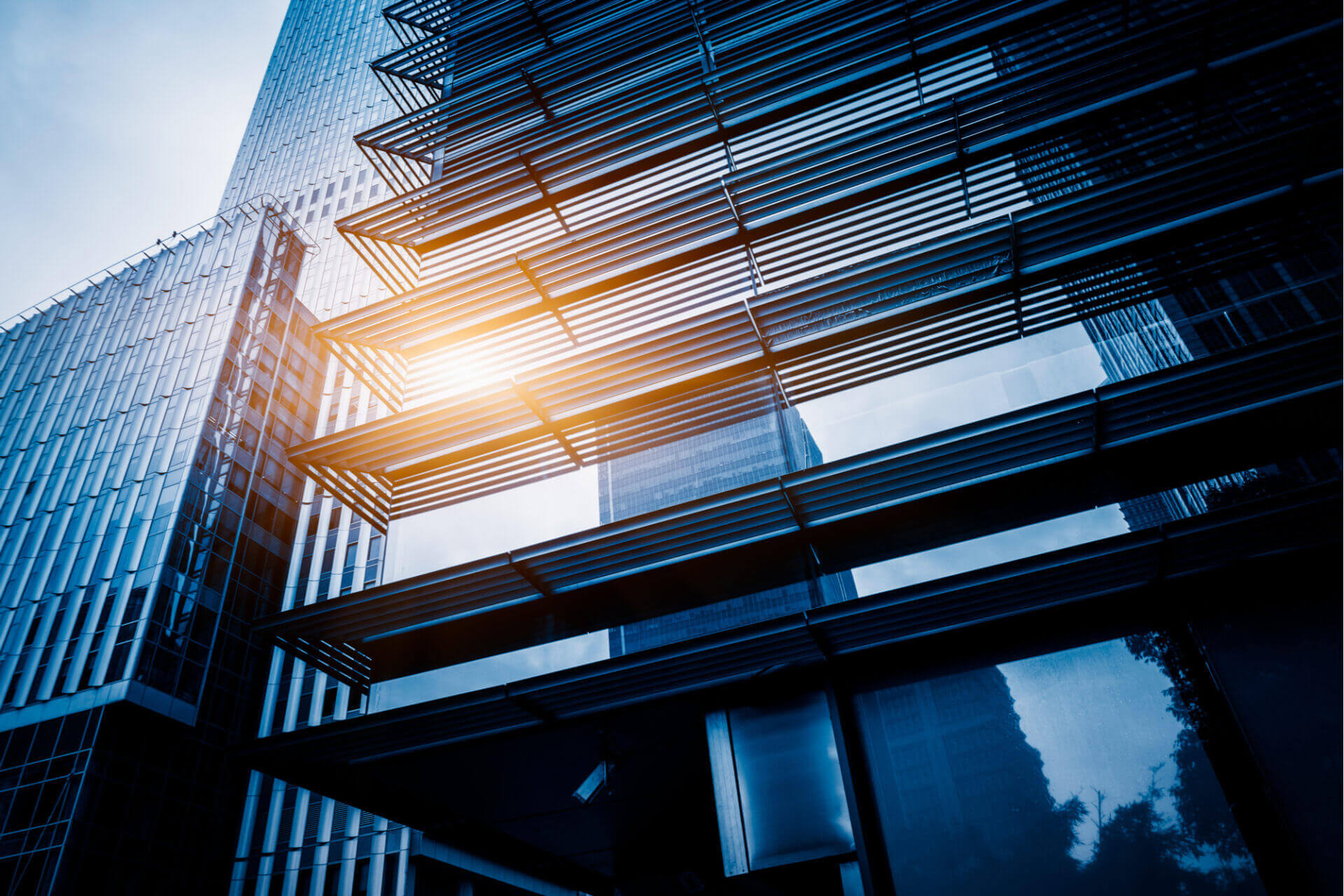 Picture of blue office building with windows.