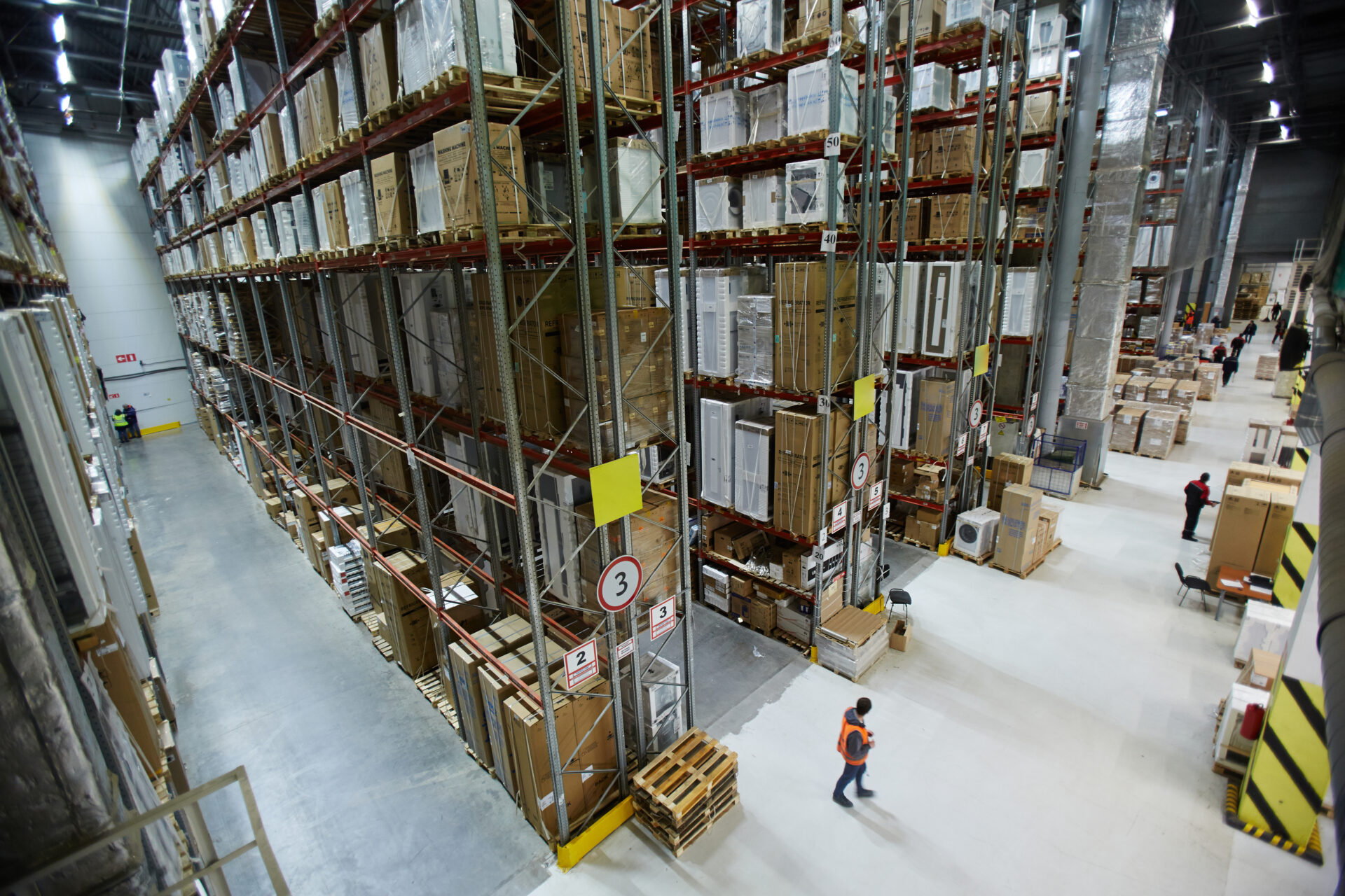 Modern warehouse factory with goods and workers