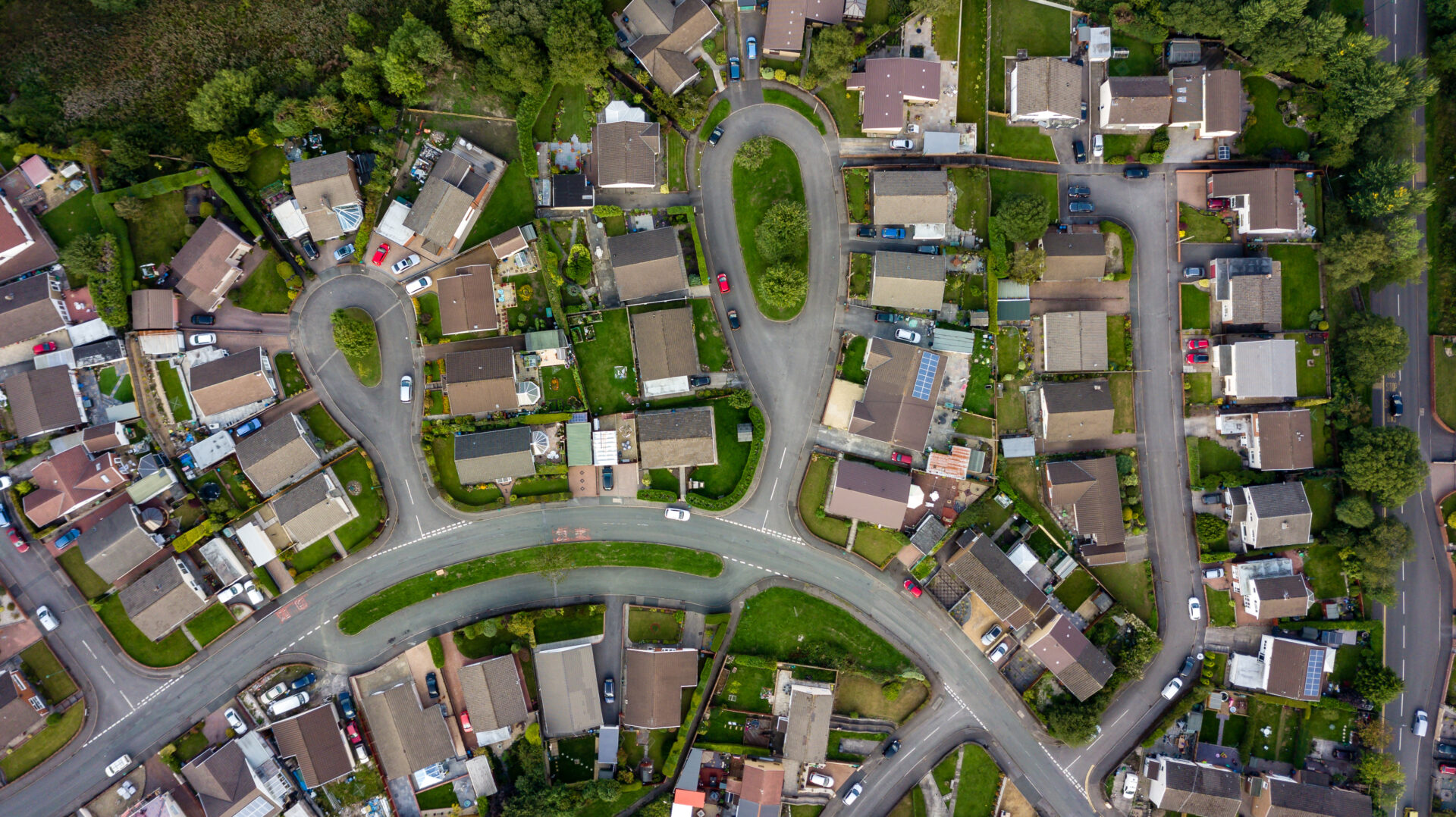 Top down aerial view of urban houses and streets in a residential neighborhood